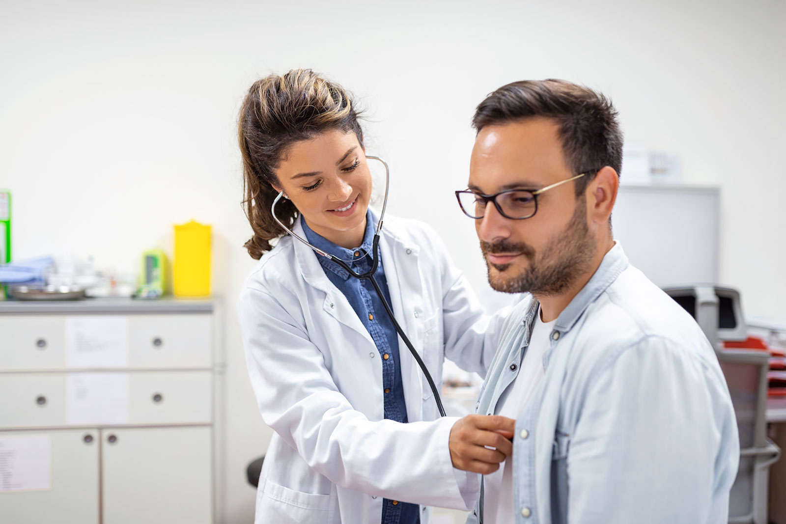Female Doctor listening to the heart of a young man | What Does a Primary Care Doctor Do? | Primary Care Johns Creek | North Chattahoochee Family Physicians - High Cholesterol | Johns Creek High Cholesterol Specialist in Atlanta